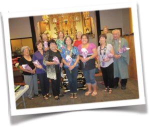 BWA officers holding flowers, with Rev. Sumikawa