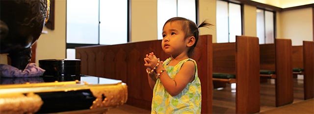 little girl with hands together approaches altar area