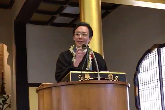 Rev. Satoshi Tomioka giving a dharma message at Moiliili Hongwanji